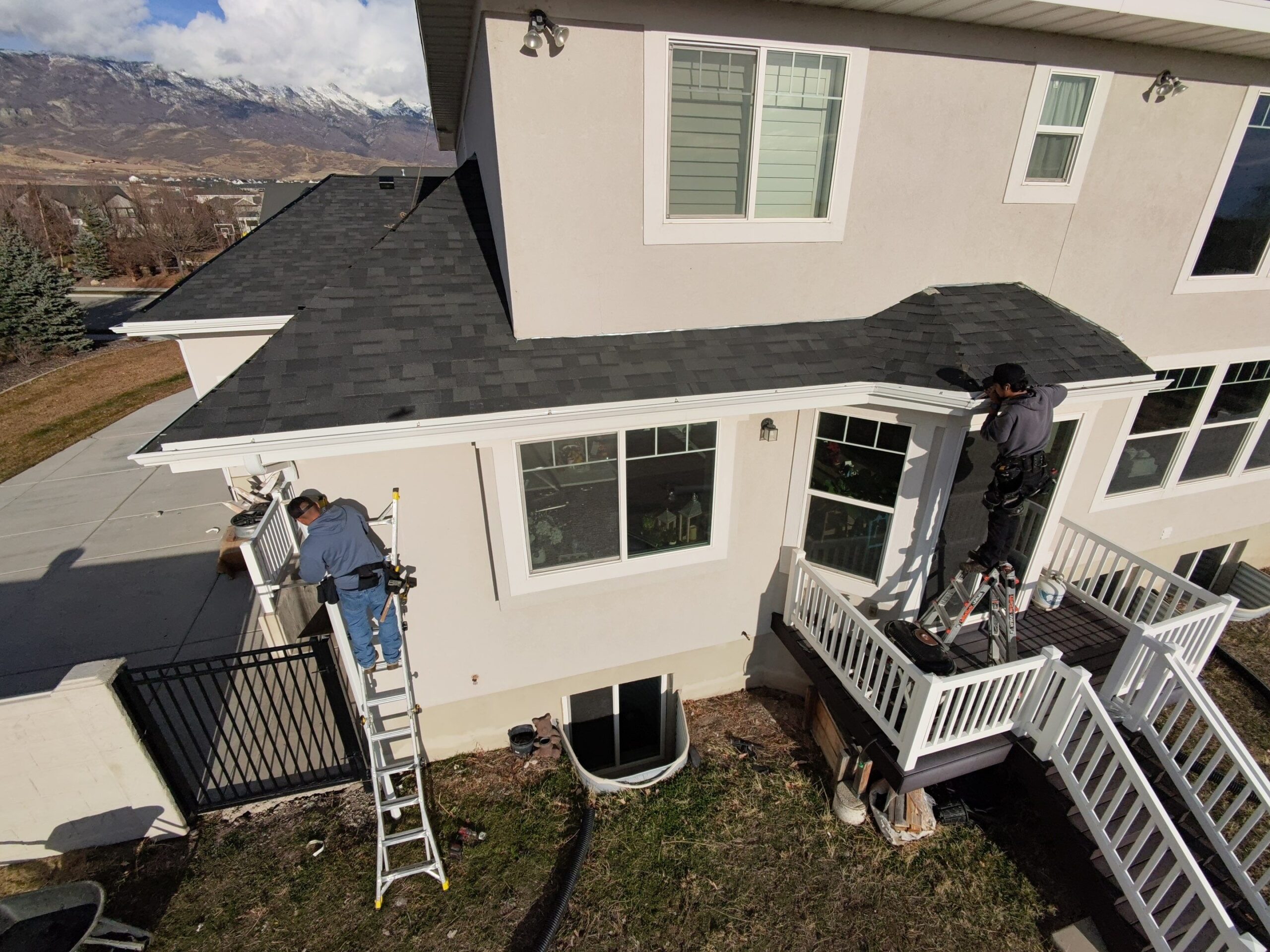 Rooval Roofing crew working on a roof edge in Highland, Utah
