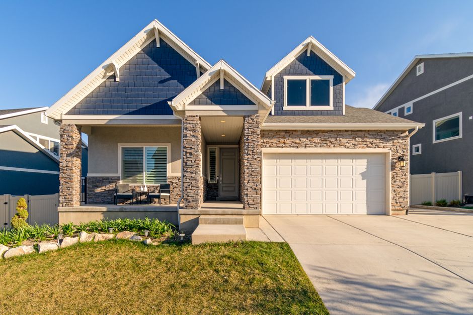 Craftsman home with a stone facade under a blue sky, American Fork, Utah style