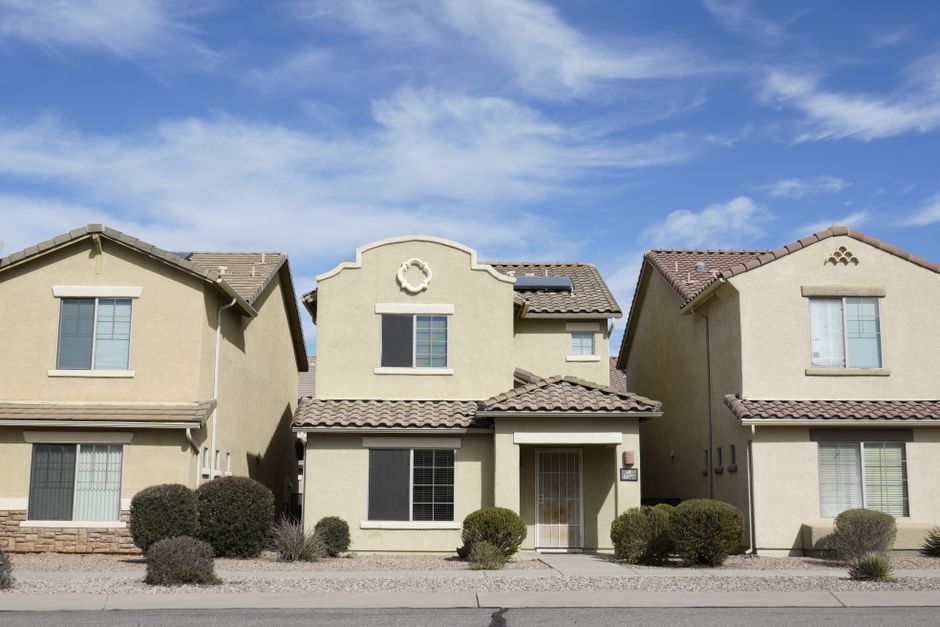 Tan stucco homes under a wide blue sky, Bluffdale, Utah style