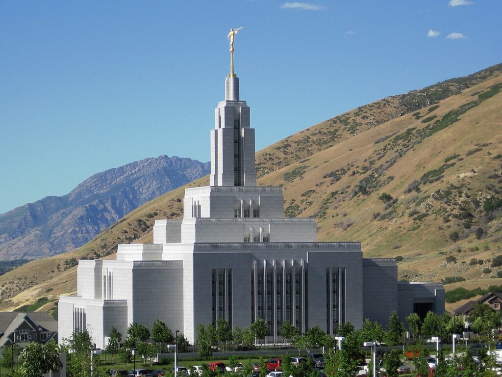 Draper Utah Temple on the hillside under a blue Utah sky