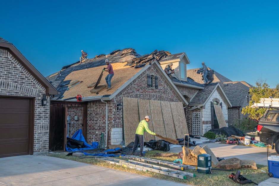 Roofing crew replacing shingles on a Draper, Utah home