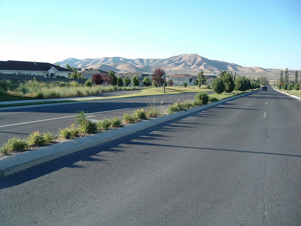 Residential street in Eagle Mountain, Utah below the dry foothills