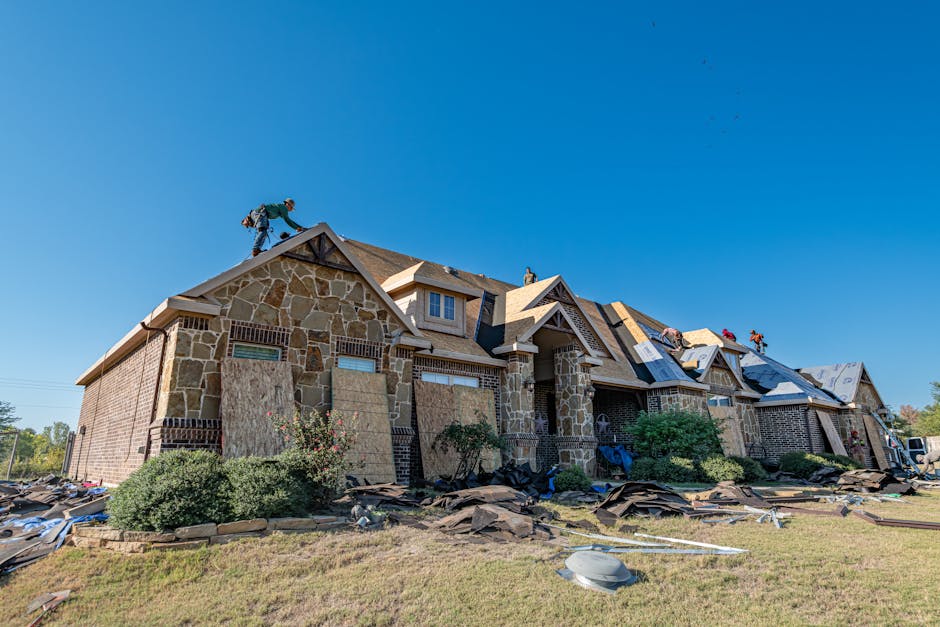 Crew re-roofing a large stone home in Eagle Mountain, Utah