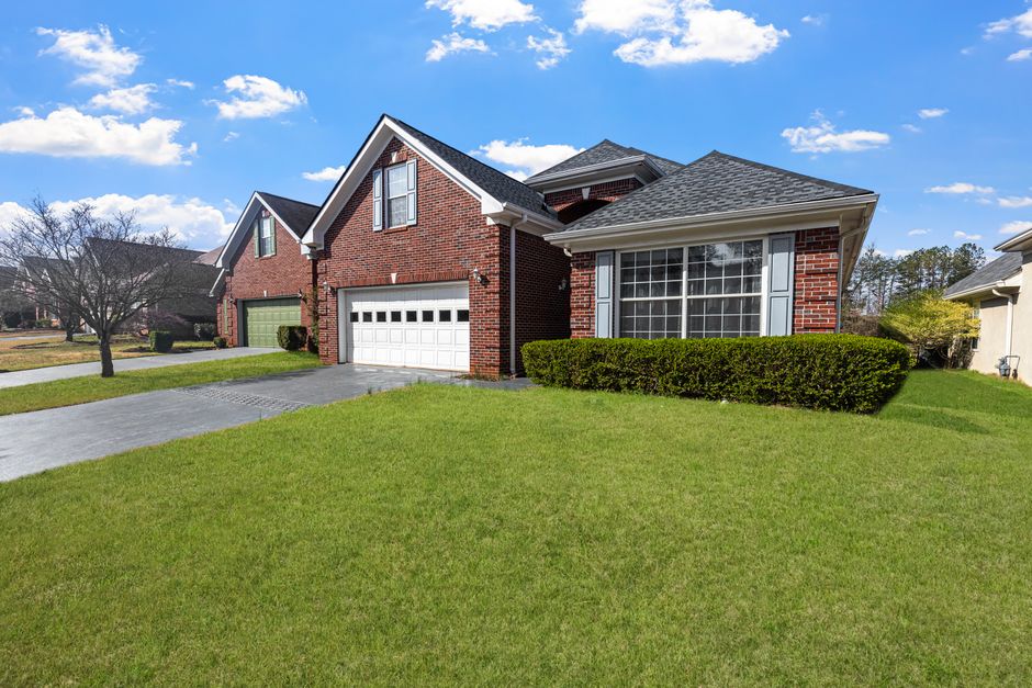 Brick single-story home with a shingle roof, Murray, Utah style neighborhood