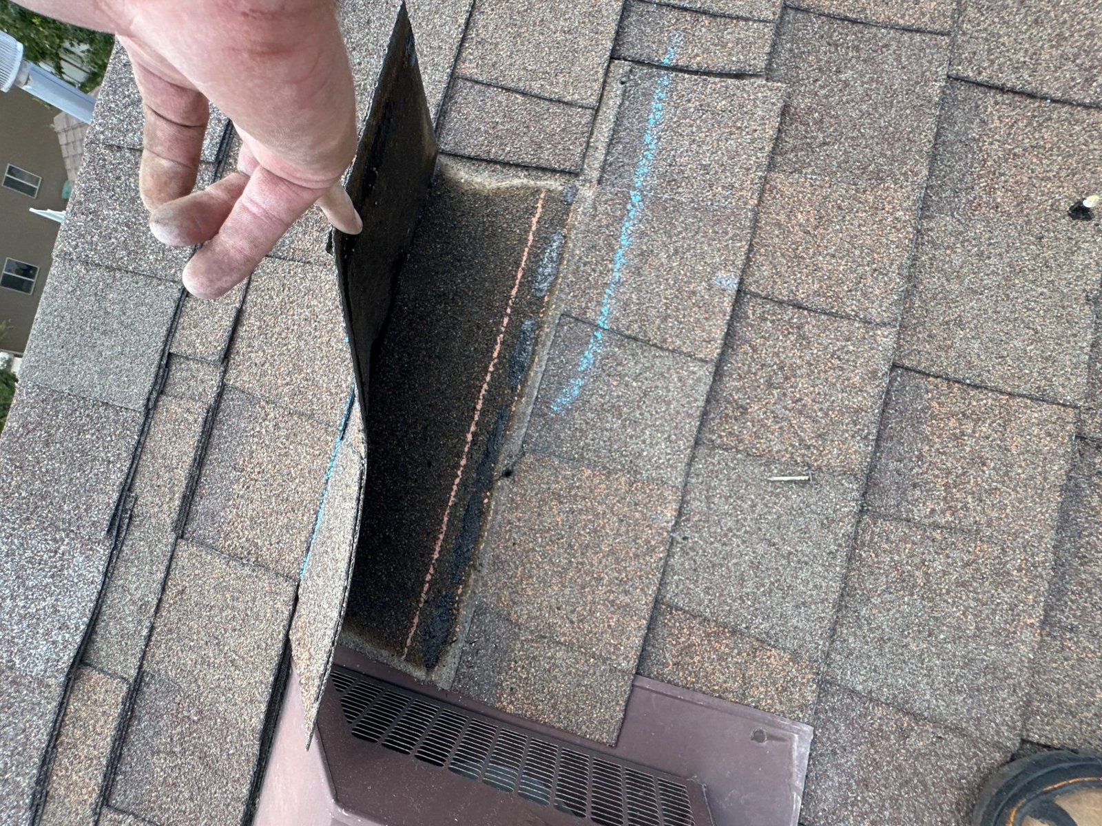 Rooval inspector marking damaged shingles during a roof inspection in Murray, Utah