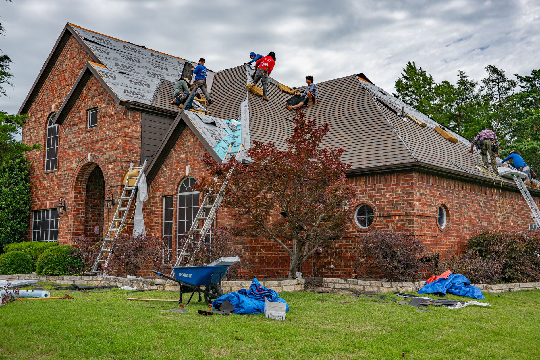 Roofing crew replacing the roof on a two-story Utah home