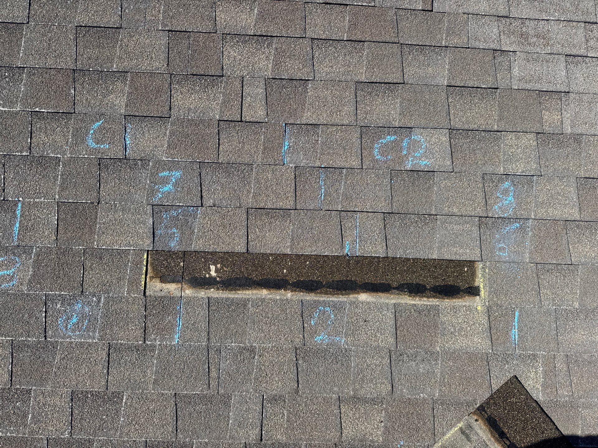 Missing shingle exposed on an asphalt roof — Rooval inspection photo