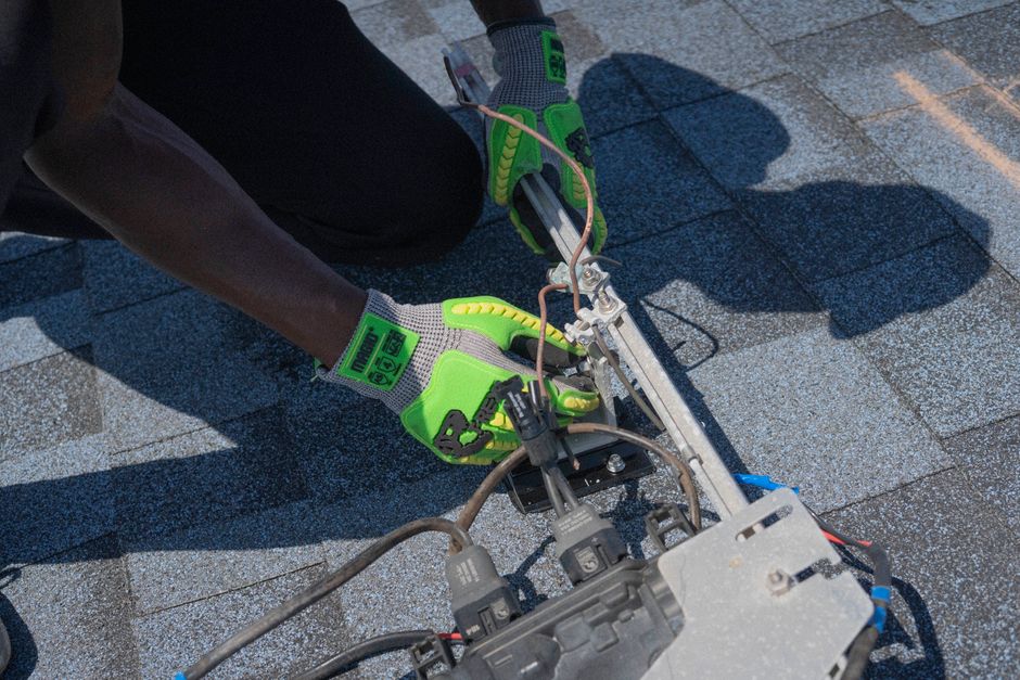 Close-up of a roofer installing shingles in Sandy, Utah