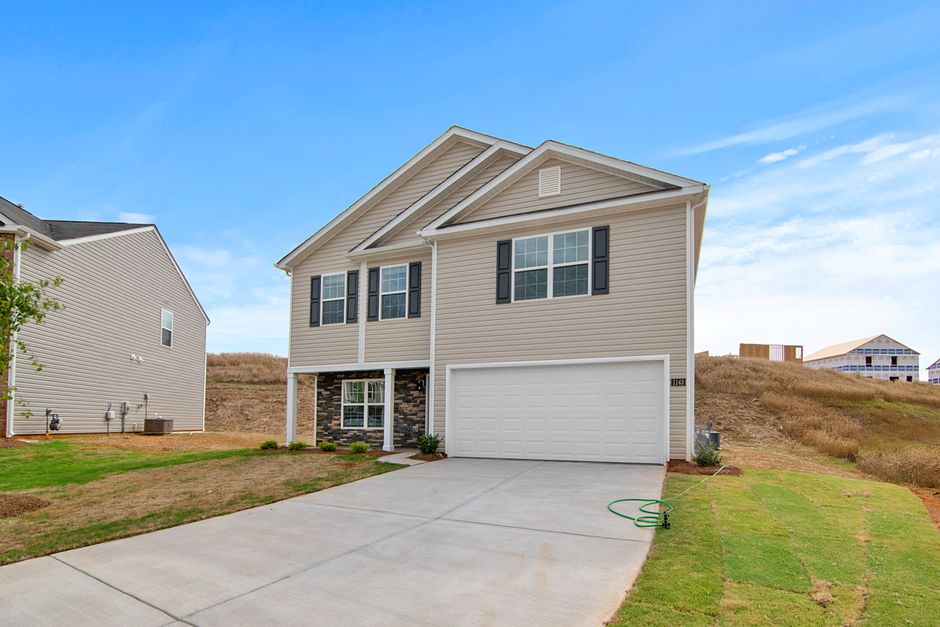 Two-story home with stone accents below dry foothills, Springville, Utah style