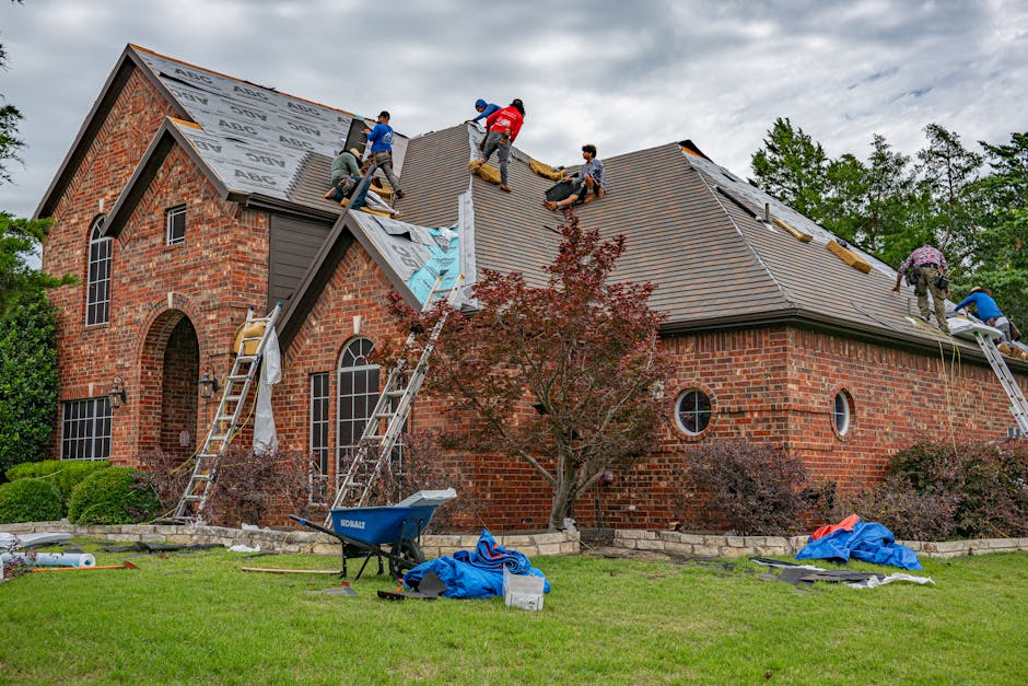 Roofing crew replacing a roof on a brick Springville, Utah home