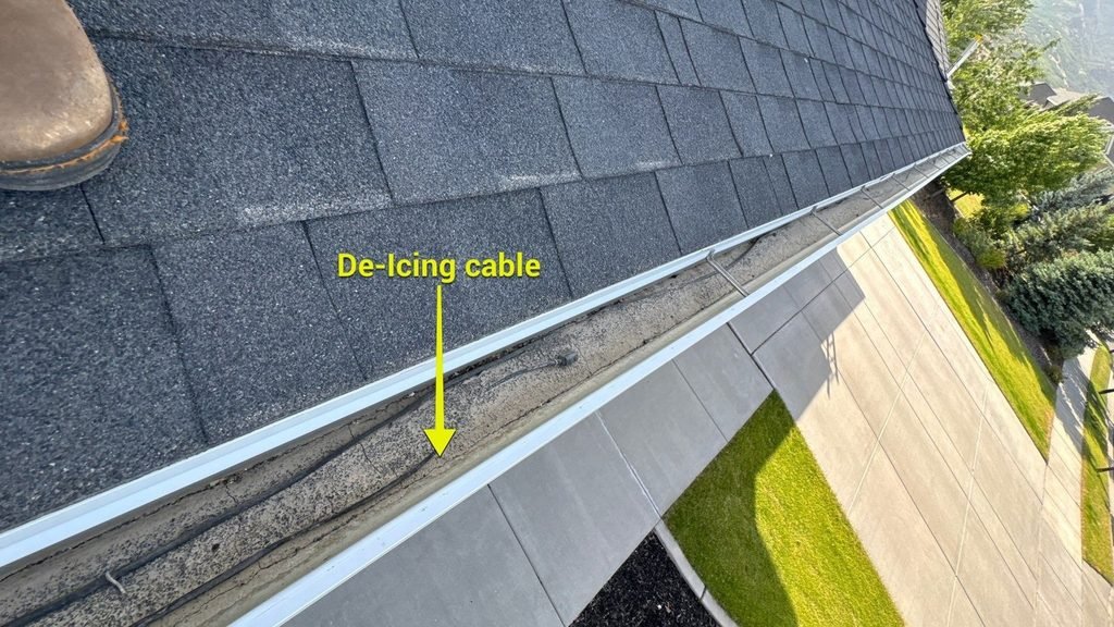Roof inspector photo of de-icing heat cable installed in a gutter