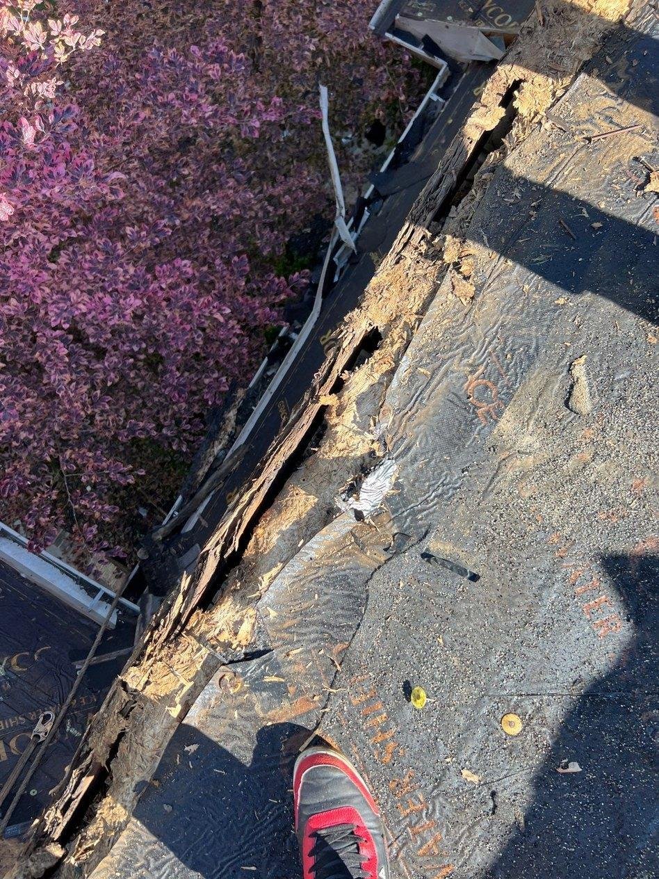Crumbling, water-damaged roof sheathing along eave edge caused by chronic winter ice dams on a Mapleton, Utah house