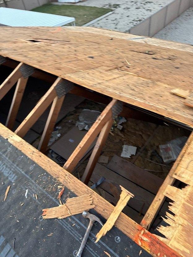 Damaged plywood roof sheathing neatly cut back to the centerline of rafters exposing solid framing flanges in Salt Lake County, Utah