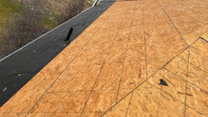 New 7/16-inch OSB roof decking panels and black self-adhering ice barrier membrane installed along eaves on a Highland, Utah home