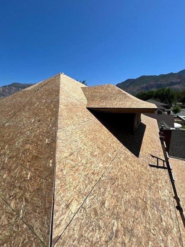 Fresh solid APA-rated 7/16-inch OSB roof sheathing panels installed over historic spaced boards on an Ogden, Utah residential roof